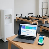 please add an image of a water cooler that doesnt show the water bottle in a gym studio managing software on a laptop and a phone different pilates re please add an image of a water cooler that doesnt show the water bottle in a gym studio managing software on a laptop and a phone different pilates re