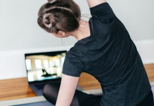 women working out to laptop